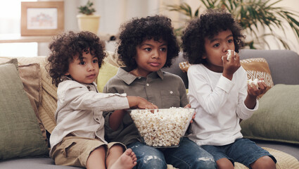 Eating popcorn, couch and children in living room for bonding, cartoons and entertainment in school...