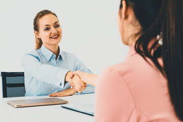 Two young business women in meeting at office table for job application and business agreement....