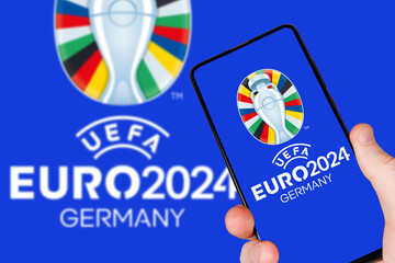 Naklejka premium UEFA Euro 2024 Germany European Football Championship Europe logo on a mobile photomontage in Germany