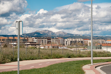 Urban Landscape with Mountain Backdrop and Wind Turbines