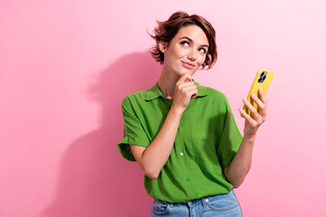 Photo of cute dreamy young woman dressed green shirt arm chin reading modern gadget empty space...