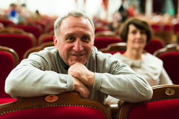 Mature man in theater watching a performance