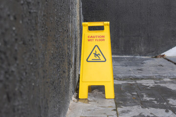 A yellow caution sign is on the ground
