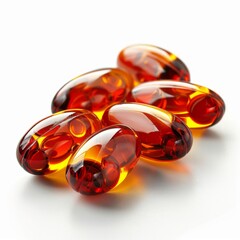 a group of red and yellow pills on a white surface