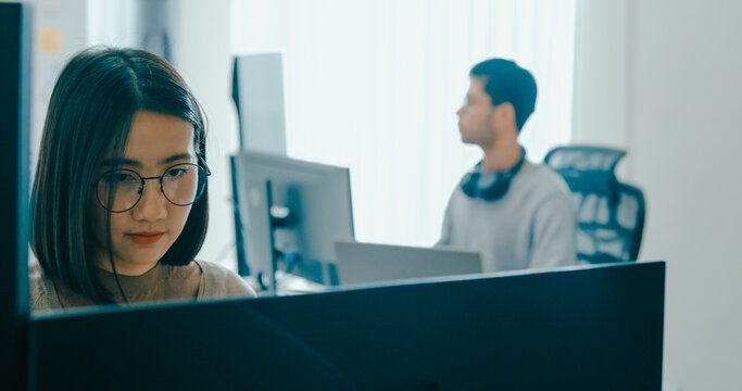 Group Adult Asia male, female freelance typing write prompt AI bot IT app smart program nomad, video game, terminal with coding language, user interface, designer, big data center on desktop computer.