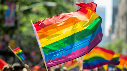 Gay rainbow flag seen during pride parade in the city. Parade goers participate in gay pride march. Stock Photo photography