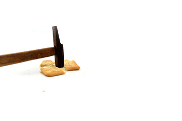 malkist crackers on a white background are hit by a hammer