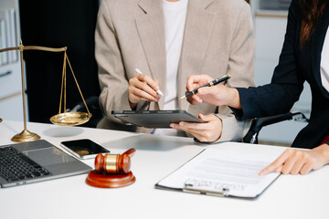 Business and lawyers discussing contract papers with brass scale on desk. Law, legal services,...