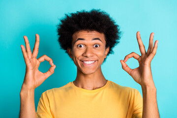Portrait of optimistic man with afro hairstyle wear oversize t-shirt showing okey approve nice job...