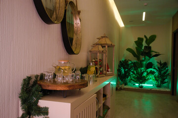 Decorative items and tea corner on the console in the hallway