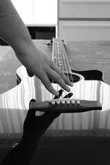 Close Up Photo Of A Guitar And A Hand Touching The Strings