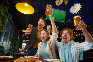 Friends crazy screaming supporting soccer team watching match at sports bar