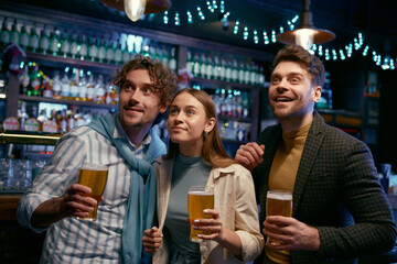 Happy friends sharing emotion and discussing their lives while rest at pub