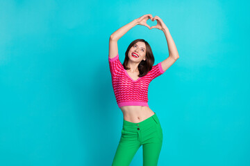Photo of adorable girlish woman with straight hairdo dressed knitwear top look at heart symbol over...