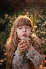 children's photo session with dandelions and a butterfly at sunset