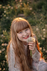 children's photo session with dandelions and a butterfly at sunset