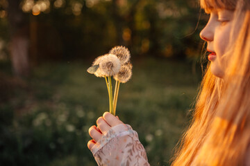 children's photo session with dandelions and a butterfly at sunset