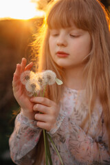 children's photo session with dandelions and a butterfly at sunset