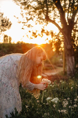 children's photo session with dandelions and a butterfly at sunset