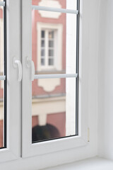 Modern pvc window with double glazing pane, white frame and handles