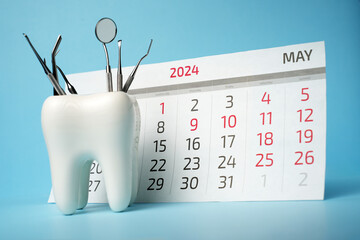 Dentist appointment calendar on a blue background with copy space