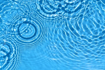 Blue water ripple surface. Clear water texture with beautiful splashing ripples and bubbles. spa...
