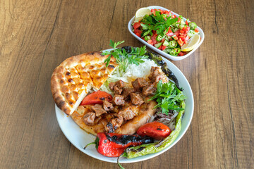 A dish of grilled lamb with appetizers, a traditional Turkish dish