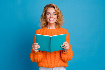 Photo of adorable lovely woman wear trendy orange clothes hold book novel story isolated on blue...
