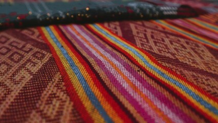 Close up side view handmade woven fabric with unique pattern from Indonesia, selective focus,...