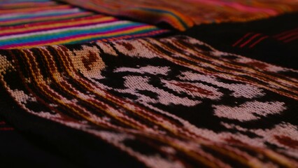 Close up side view handmade woven fabric with unique pattern from Indonesia, selective focus,...