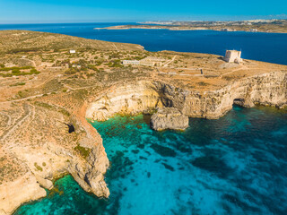 Crystal lagoon, Tower on Comino island. Mediterranean sea, Malta