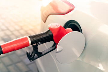 refueling a car at a gas station, cost of gasoline