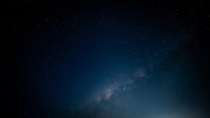 The Milky Way shines brightly in the night sky, showcasing the vastness of the cosmos. Stars fill the dark expanse, creating a stunning celestial view that highlights the beauty of our galaxy.