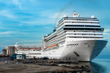 White cruise ship awaits passengers in the port of Rhodes.