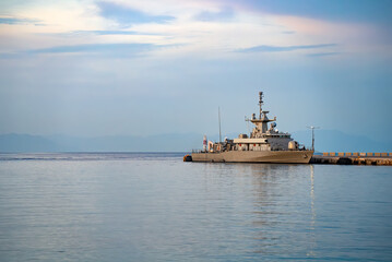 Modern patrol navy vessel in port.