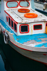 Old colored fishing boat in the port.