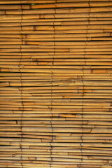 Close-up of a stacked bamboo mat, highlighting natural patterns and warm tones.