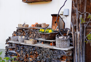 a traditional alpine farmhouse with a pile of firewood under the window in the Bavarian alpine...