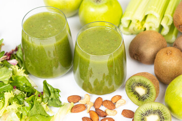 Healthy vegetable smoothie in glasses on white background.