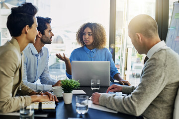 Obraz premium Business woman, laptop and coaching with team in meeting, presentation or conference at office. Female person talking to group of employees in finance for company strategy, growth or revenue at desk