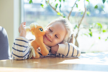 Kid Girl Smiling with Stuffed Toy