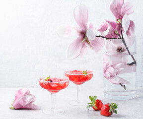 Strawberry Margarita cocktail and a blossoming magnolia branch