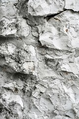 Texture of a stone with a grainy and uneven surface in a light gray color.