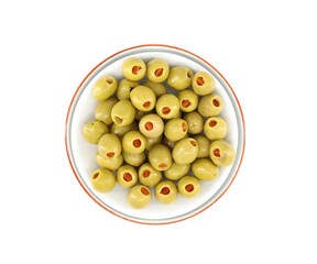 Green olives stuffed with red peppers in a bowl on white background. Top view.
