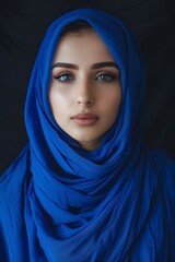 Naklejka premium beautiful muslim woman with blue hijab on dark background