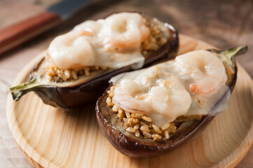 eggplant in two halves stuffed with rice and shrimp