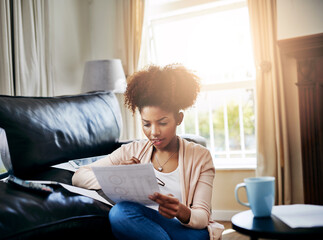 Budget, planning and black woman in home with paperwork, document and review investment report....