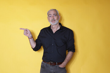 mature man pointing isolated on background