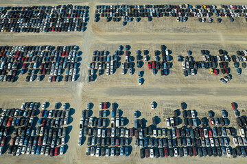 Obraz premium Aerial view of auction reseller company big parking lot with parked cars ready for remarketing services. Sales of secondhand vehicles