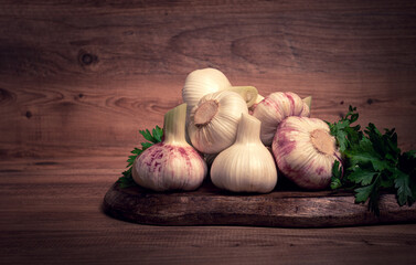 Fresh young garlic, white and purple color, on a wooden table, no people,
